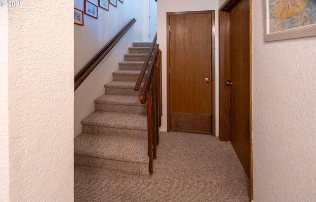 43605 State Highway 38 Unit 41, Reedsport, OR 97467 - stairway featuring carpet floors and a textured wall