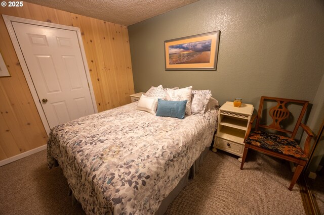 43605 State Highway 38 Unit 41, Reedsport, OR 97467 - bedroom featuring carpet, a textured ceiling, and wooden walls
