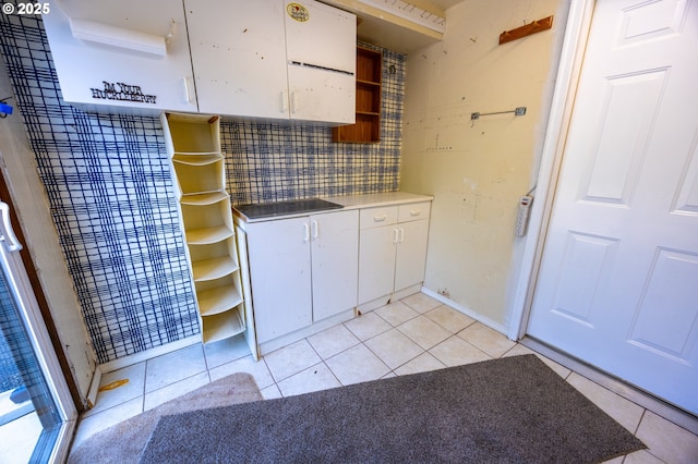43605 State Highway 38 Unit 41, Reedsport, OR 97467 - kitchen featuring open shelves, white cabinets, light tile patterned floors, and backsplash