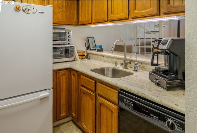 43605 State Highway 38 Unit 41, Reedsport, OR 97467 - kitchen with freestanding refrigerator, black dishwasher, stainless steel microwave, and brown cabinets