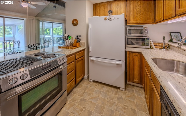 43605 State Highway 38 Unit 41, Reedsport, OR 97467 - kitchen featuring appliances with stainless steel finishes, brown cabinets, ceiling fan, and a peninsula