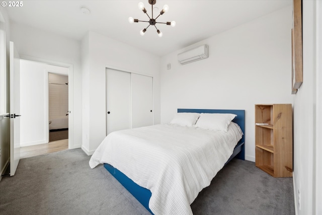 bedroom featuring an AC wall unit, a closet, an inviting chandelier, and dark carpet