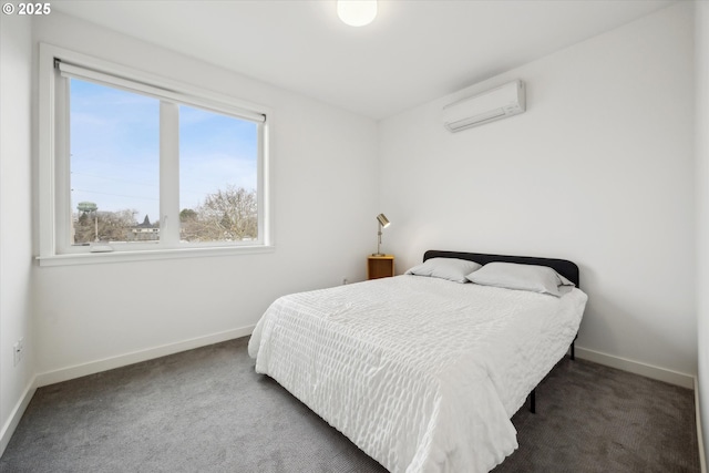 bedroom featuring an AC wall unit and dark carpet