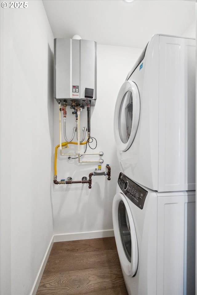 laundry room with stacked washing maching and dryer, dark hardwood / wood-style floors, and tankless water heater