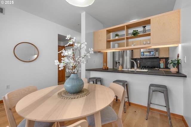 725 NW 10th Ave Unit 503, Portland, OR 97209 - dining area with light wood finished floors and baseboards