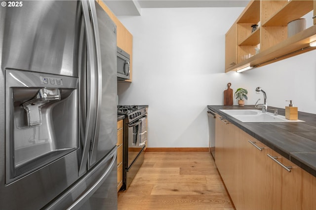 725 NW 10th Ave Unit 503, Portland, OR 97209 - kitchen featuring stainless steel appliances, light wood finished floors, dark countertops, and open shelves