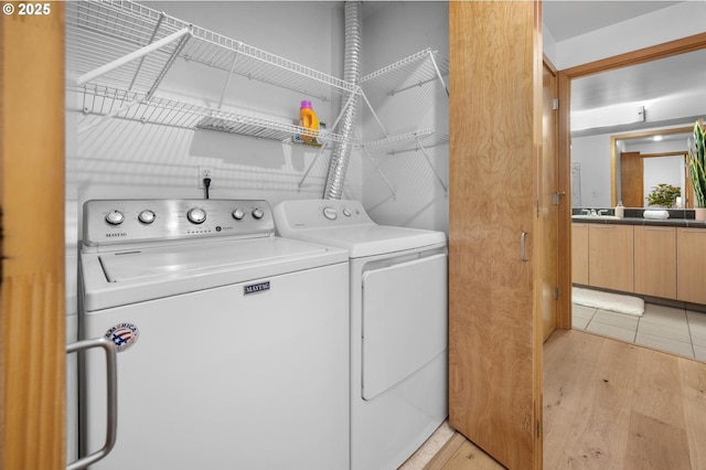 725 NW 10th Ave Unit 503, Portland, OR 97209 - laundry area featuring independent washer and dryer and light wood finished floors