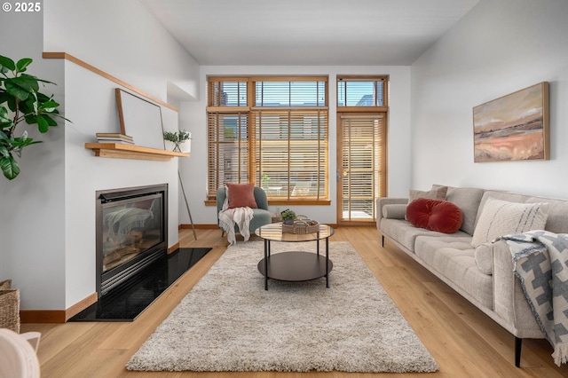 725 NW 10th Ave Unit 503, Portland, OR 97209 - living area with a glass covered fireplace and light wood-type flooring