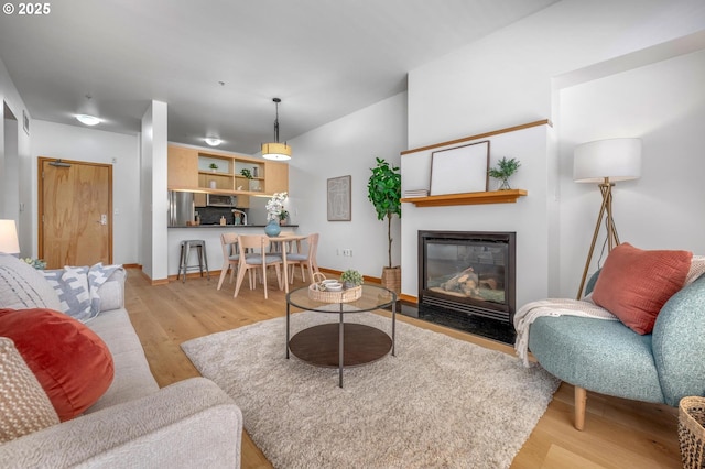 725 NW 10th Ave Unit 503, Portland, OR 97209 - living area with wood finished floors and a fireplace with flush hearth