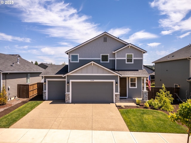 24200 SW Chestnut Ter, Sherwood, OR 97140 - craftsman-style home with stone siding, driveway, board and batten siding, and a garage