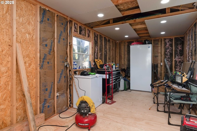 misc room with washer / clothes dryer and light wood-type flooring