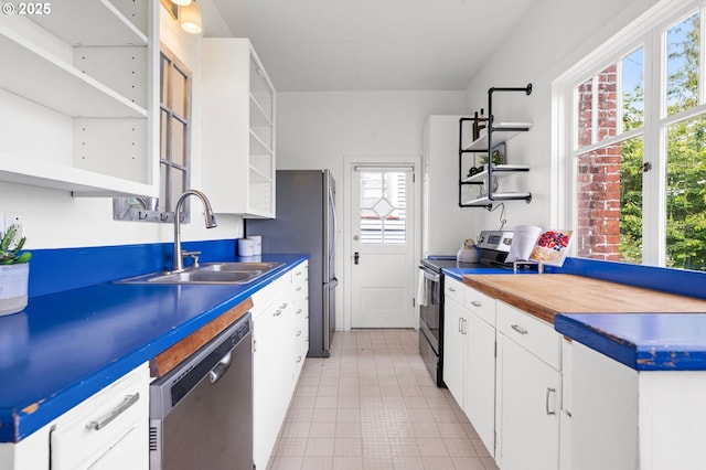 760 Jerome Ave, Astoria, OR 97103 - kitchen featuring open shelves, appliances with stainless steel finishes, white cabinets, and butcher block countertops