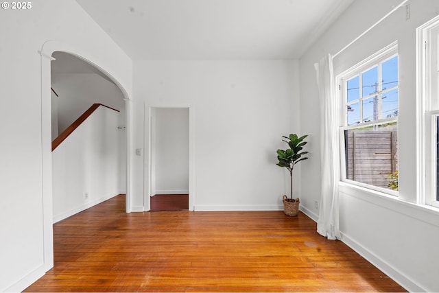 760 Jerome Ave, Astoria, OR 97103 - empty room with light wood-style flooring and arched walkways
