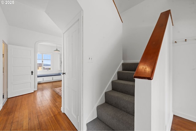 760 Jerome Ave, Astoria, OR 97103 - stairway featuring wood-type flooring, lofted ceiling, and arched walkways
