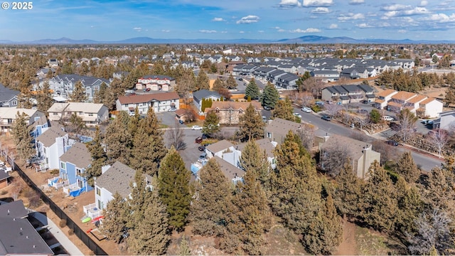 2011 NE Neil Way, Bend, OR 97701 - aerial view of property and surrounding area featuring nearby suburban area and a mountain backdrop