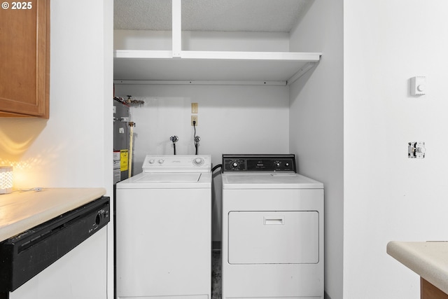 laundry room with water heater, laundry area, washer and clothes dryer, and a textured ceiling