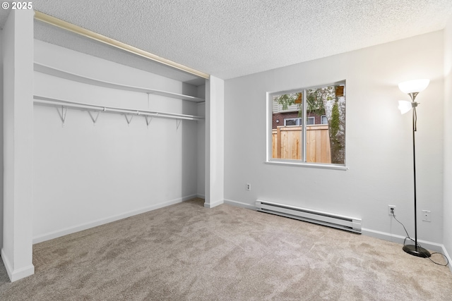 unfurnished bedroom with a textured ceiling, baseboard heating, and carpet flooring