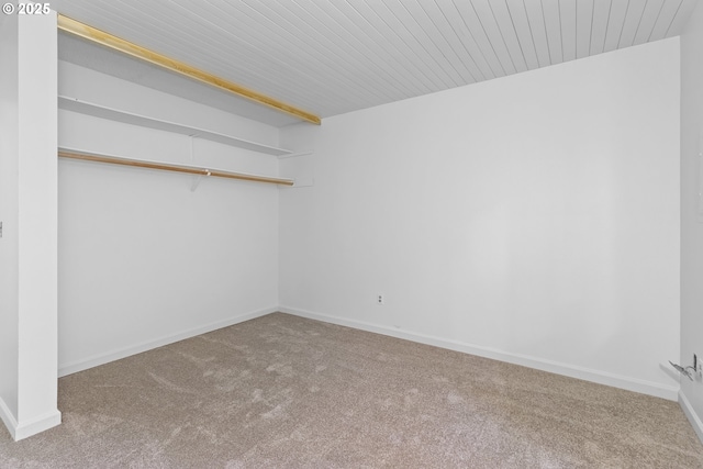 unfurnished room with carpet and baseboards