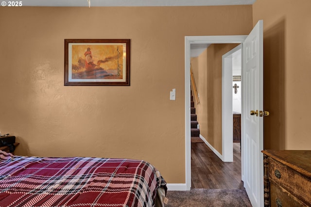 bedroom featuring baseboards and wood finished floors