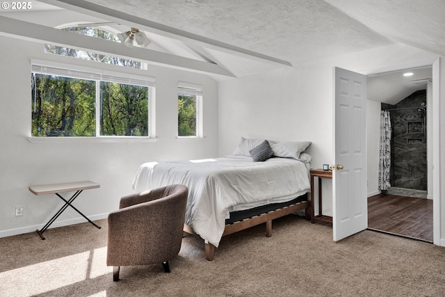 carpeted bedroom featuring freestanding refrigerator, vaulted ceiling, a textured ceiling, and baseboards
