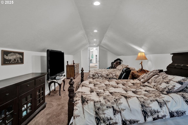 carpeted bedroom featuring lofted ceiling, recessed lighting, and ensuite bath
