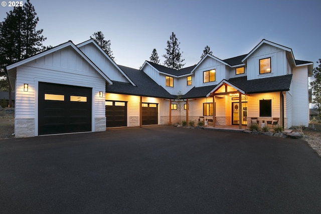 19550 Buck Canyon Rd, Bend, OR 97702 - modern farmhouse with a garage, covered porch, stone siding, board and batten siding, and driveway