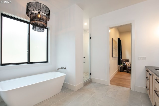 19550 Buck Canyon Rd, Bend, OR 97702 - full bath featuring vanity, baseboards, a freestanding bath, and a stall shower