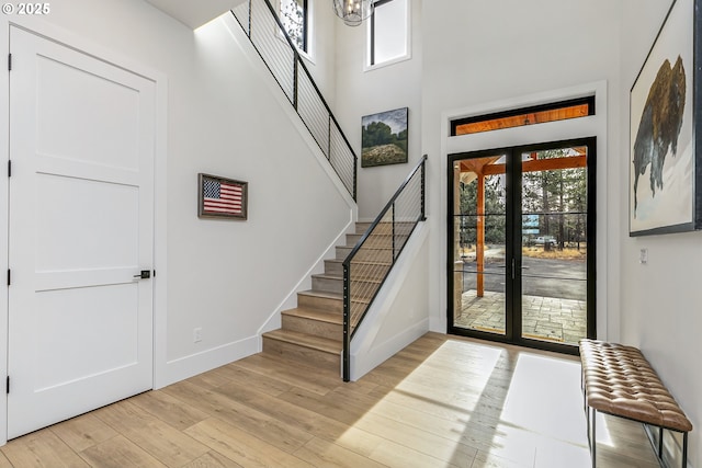 19550 Buck Canyon Rd, Bend, OR 97702 - foyer entrance featuring a high ceiling, stairs, light wood-style flooring, and a wealth of natural light