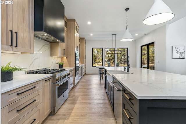 19550 Buck Canyon Rd, Bend, OR 97702 - kitchen featuring recessed lighting, a large island, wall chimney exhaust hood, and appliances with stainless steel finishes