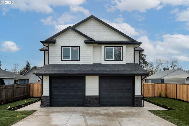 view of front of house featuring a garage and a front lawn