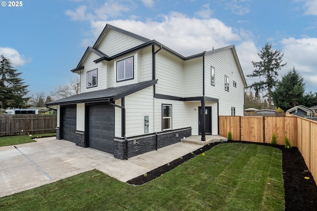 back of house with a yard and a garage