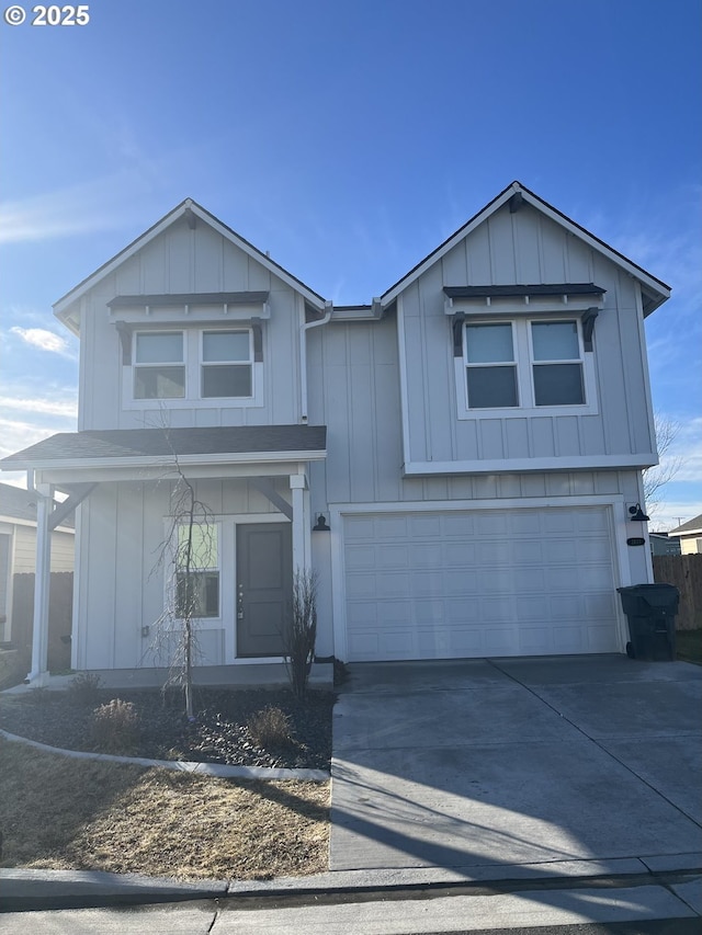 view of front of property with concrete driveway, board and batten siding, and an attached garage