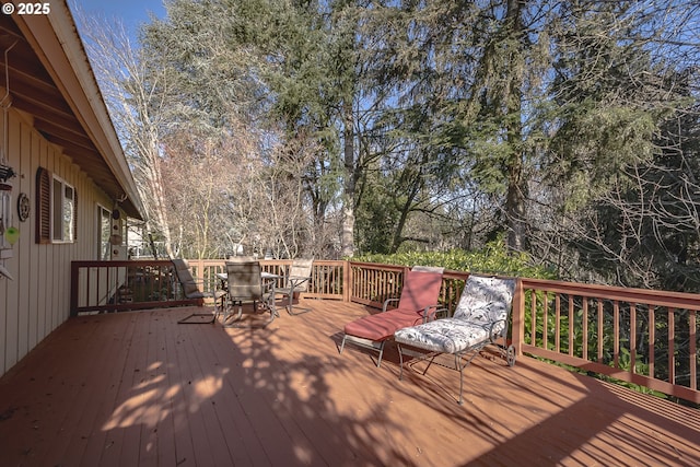 wooden terrace with outdoor dining area