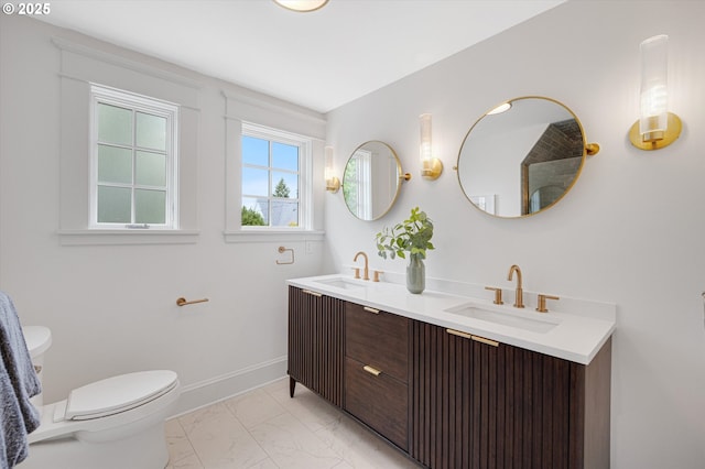 4072 NE 24th Ave, Portland, OR 97212 - full bathroom featuring marble finish floors, toilet, double vanity, and baseboards