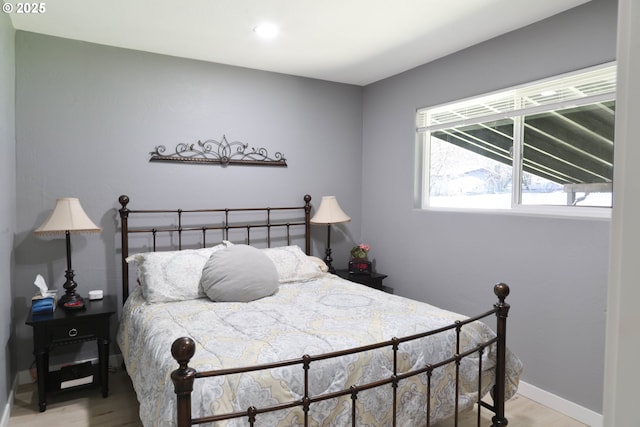 bedroom featuring baseboards and light wood-style flooring