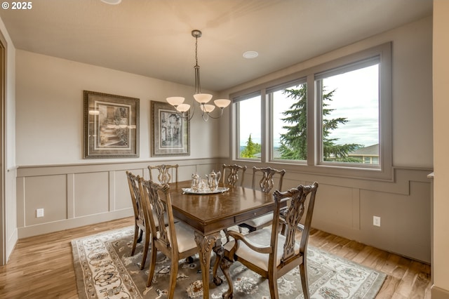 12483 SW Autumn View St, Tigard, OR 97224 - dining room with a chandelier, wainscoting, a decorative wall, and light wood-type flooring