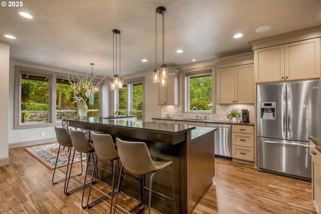 12483 SW Autumn View St, Tigard, OR 97224 - kitchen with stainless steel appliances, a kitchen island, backsplash, light wood finished floors, and recessed lighting