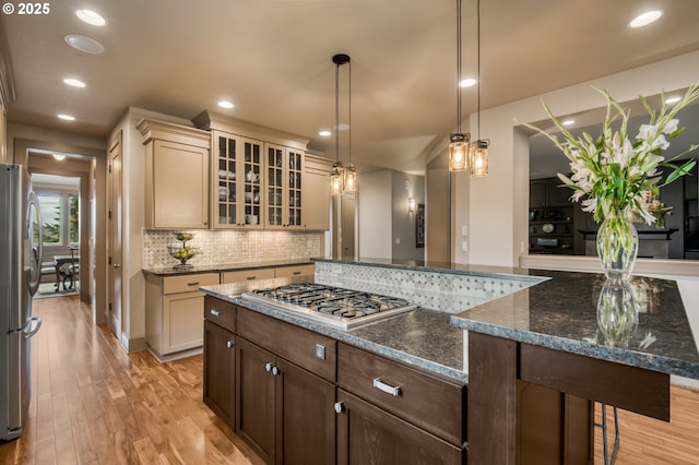 12483 SW Autumn View St, Tigard, OR 97224 - kitchen with stainless steel appliances, light wood-type flooring, decorative backsplash, glass insert cabinets, and recessed lighting