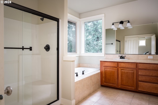 bathroom featuring a wealth of natural light, tile patterned flooring, vanity, and shower with separate bathtub