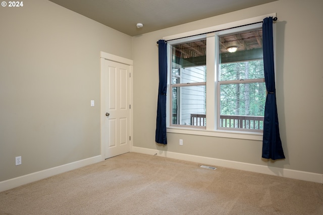 spare room with light colored carpet