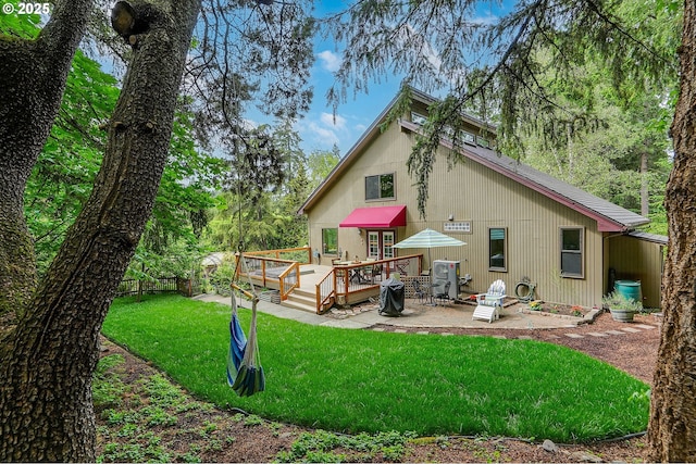 1946 Roberta Ave S, Salem, OR 97301 - back of property with a wooden deck, a lawn, and a patio area