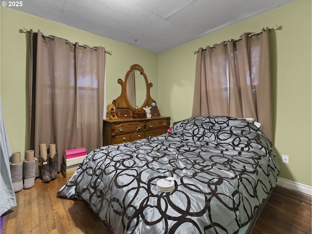 bedroom featuring wood-type flooring and a textured ceiling