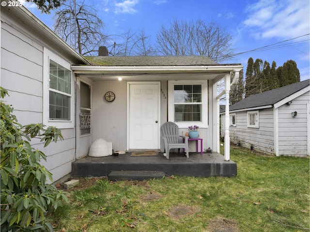 view of exterior entry with a lawn