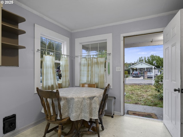 dining space featuring crown molding and concrete flooring