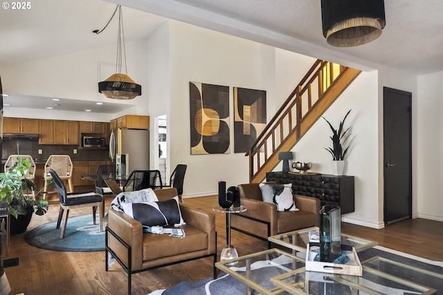 living room with wood-type flooring and high vaulted ceiling