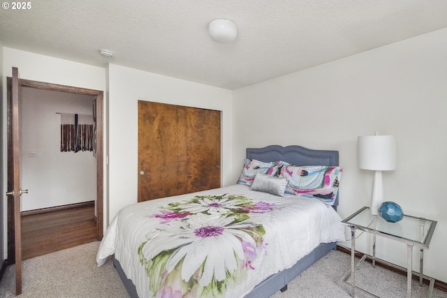 bedroom with carpet flooring and a textured ceiling