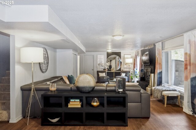 dining area featuring dark wood-type flooring and a textured ceiling