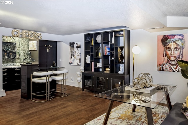 interior space featuring dark hardwood / wood-style floors and a textured ceiling