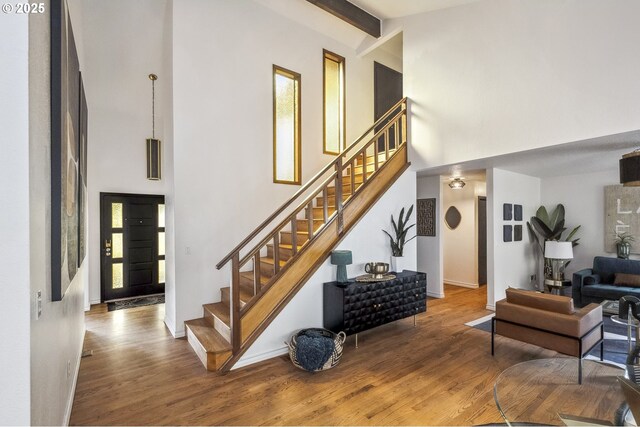 dining space featuring a towering ceiling and light wood-type flooring