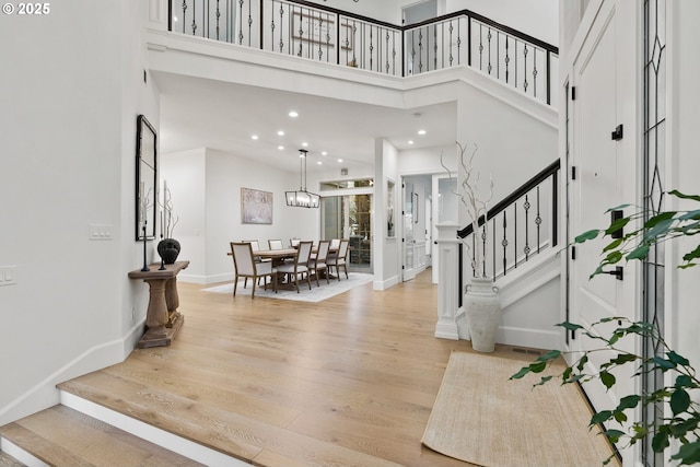 entrance foyer with a high ceiling and light wood-type flooring